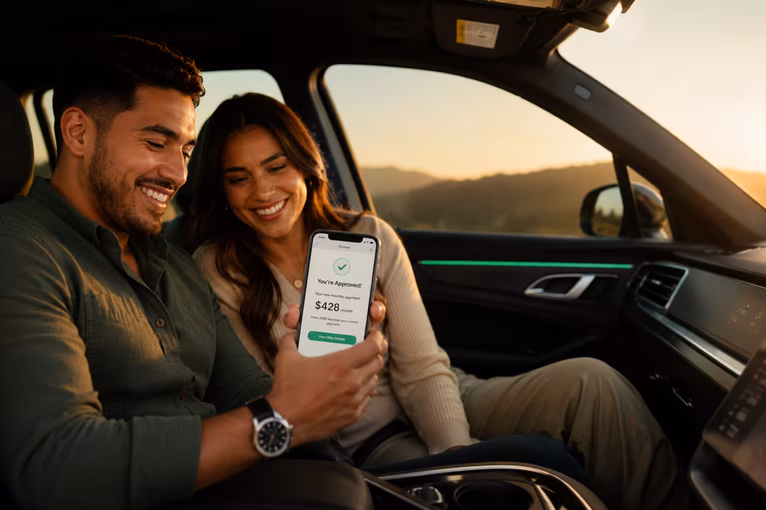 Happy couple reviewing auto loan savings